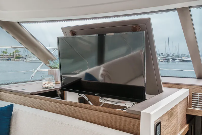 Slide: The Image of Luxurious interior of 2021 Prestige 420 Fly yacht with retractable TV and scenic marina view. - 58