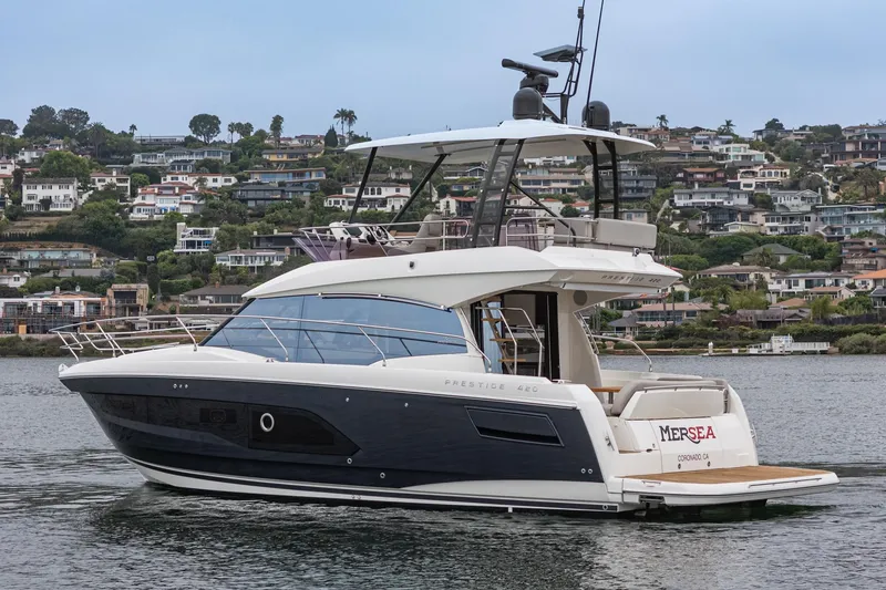 Slide: The Image of 2021 Prestige 420 Fly yacht cruising near coastal homes. - 8