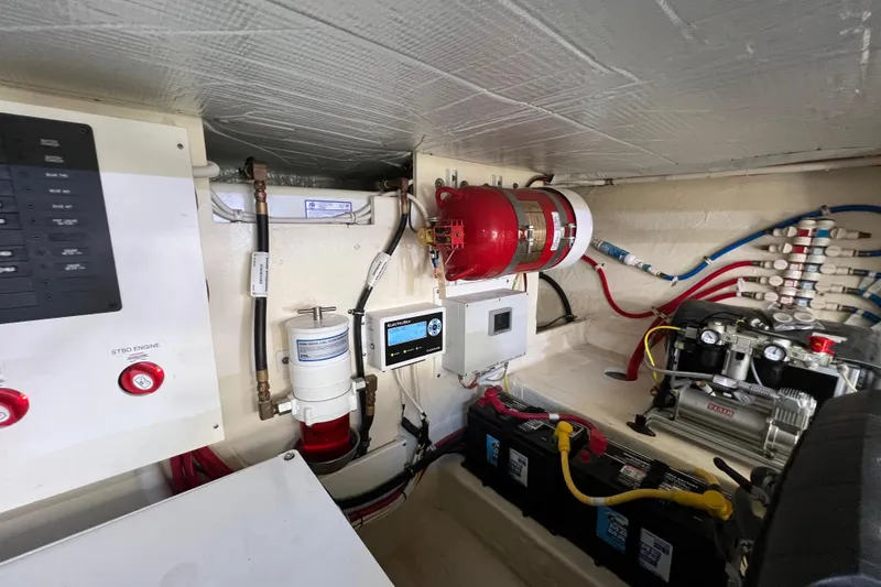 Slide: The Image of Engine room of 2020 Tiara Yachts C44 Coupe with fire suppression system and electrical components. - 101