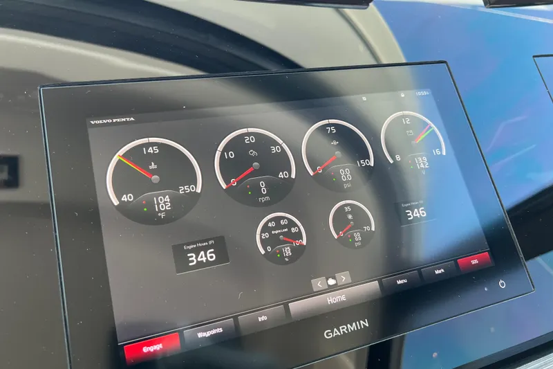 Slide: The Image of Dashboard of 2020 Tiara Yachts C44 Coupe with Garmin display showing engine metrics. - 102