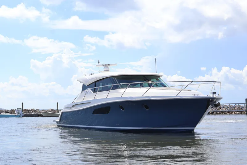Slide: The Image of 2020 Tiara Yachts C44 Coupe cruising on a sunny day with blue skies. - 11