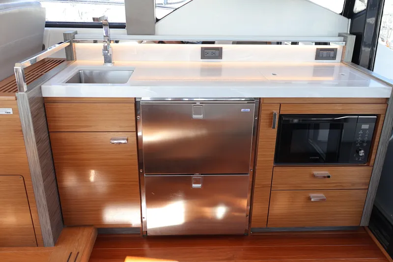 Slide: The Image of Modern kitchen area in 2020 Tiara Yachts C44 Coupe with stainless steel appliances. - 41