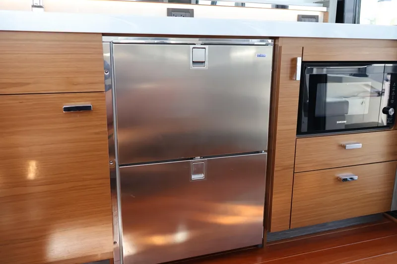 Slide: The Image of Modern kitchen area in 2020 Tiara Yachts C44 Coupe with stainless steel appliances. - 44