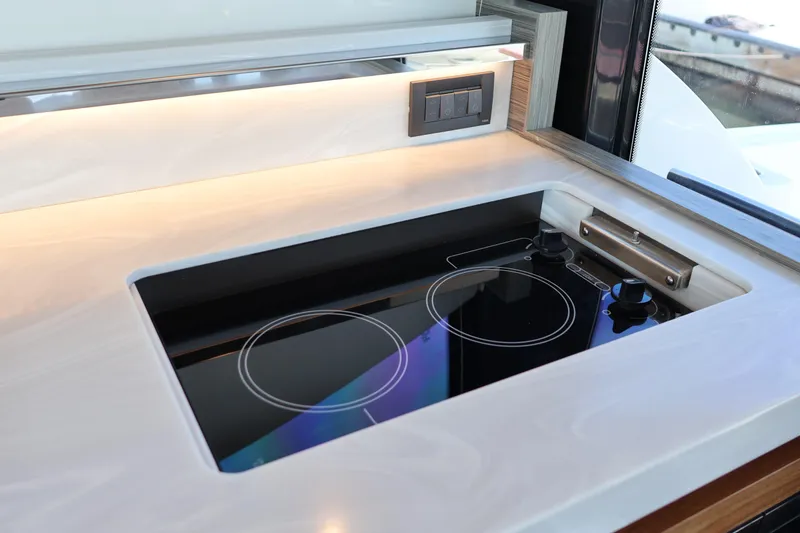 Slide: The Image of Modern kitchen cooktop on 2020 Tiara Yachts C44 Coupe, featuring sleek design and controls. - 46