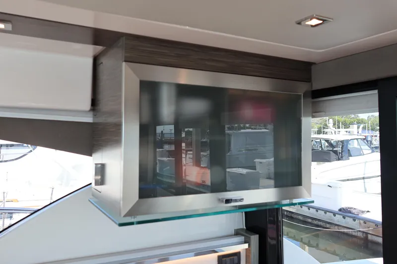 Slide: The Image of Modern interior of 2020 Tiara Yachts C44 Coupe with sleek cabinetry and window view. - 49