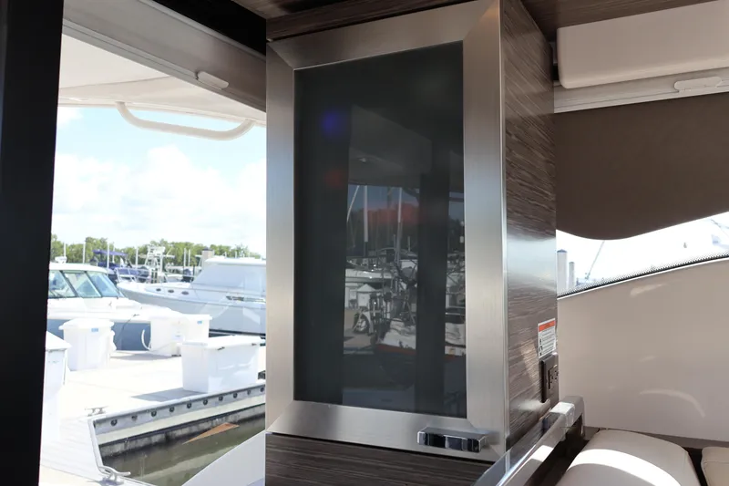 Slide: The Image of Interior view of 2020 Tiara Yachts C44 Coupe, showcasing sleek design and marina backdrop. - 51