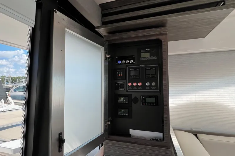 Slide: The Image of Control panel inside 2020 Tiara Yachts C44 Coupe, showcasing various switches and displays. - 52