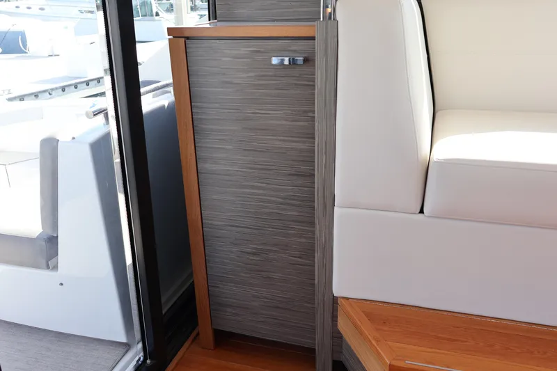 Slide: The Image of Interior of 2020 Tiara Yachts C44 Coupe, featuring sleek wood and leather design elements. - 54