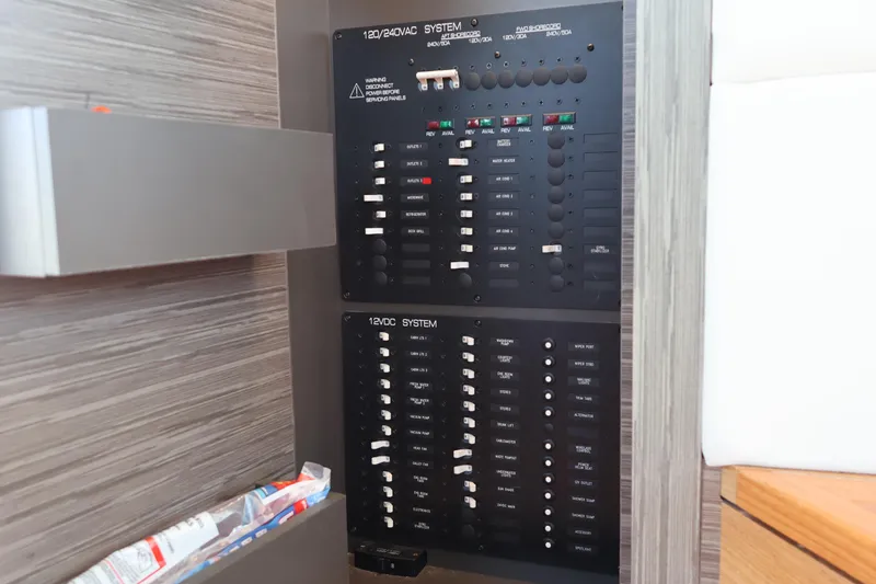 Slide: The Image of Electrical panel on 2020 Tiara Yachts C44 Coupe, showcasing 120/240VAC and 12VDC systems. - 56