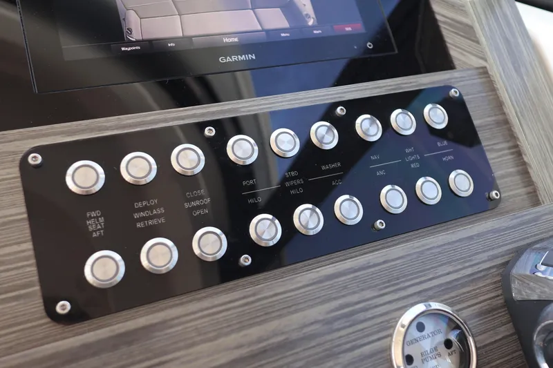 Slide: The Image of Control panel of 2020 Tiara Yachts C44 Coupe with Garmin display and various buttons. - 69