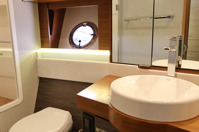 Slide: The Image of Luxurious bathroom interior of 2020 Tiara Yachts C44 Coupe with modern fixtures and porthole. - 84