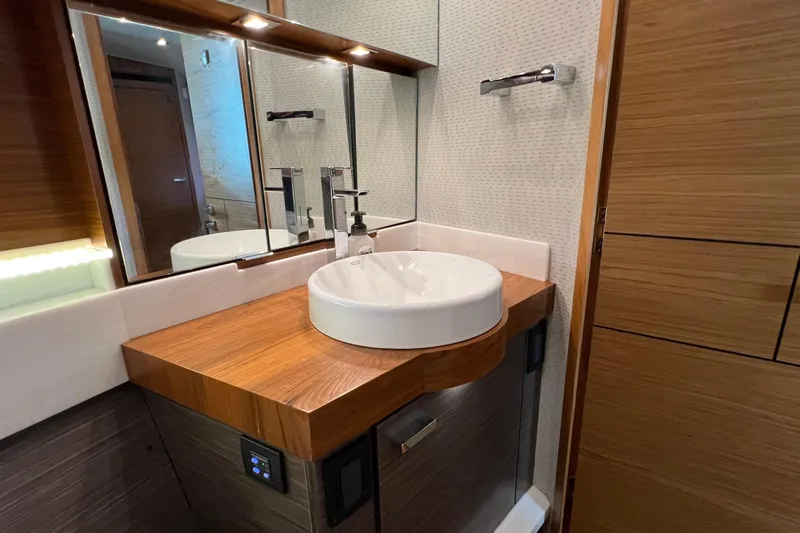 Slide: The Image of Luxurious bathroom in 2020 Tiara Yachts C44 Coupe with modern sink and wooden accents. - 85