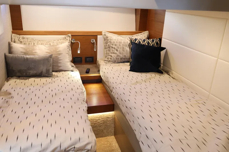 Slide: The Image of Luxurious twin cabin interior of 2020 Tiara Yachts C44 Coupe with elegant bedding. - 89
