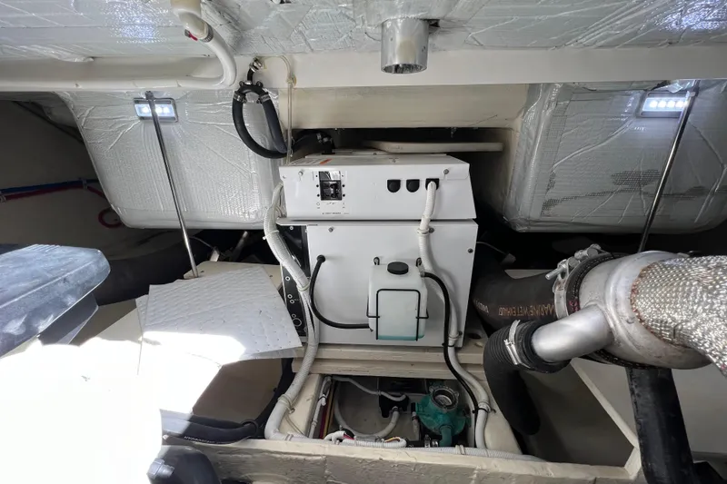 Slide: The Image of Engine room of 2020 Tiara Yachts C44 Coupe, showcasing mechanical components and insulation. - 97