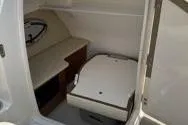 Slide: The Image of 2013 Chaparral Sunesta 224 boat interior cabin with seating and storage. - 12