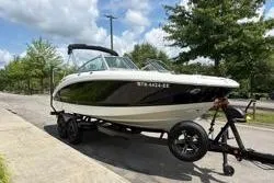 Slide: The Image of 2013 Chaparral Sunesta 224 boat on trailer, parked on a sunny street. - 3