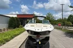 Slide: The Image of 2013 Chaparral Sunesta 224 boat on trailer, parked outdoors under a cloudy sky. - 6