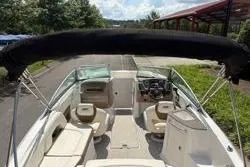 Slide: The Image of 2013 Chaparral Sunesta 224 boat interior with seating and steering wheel. - 7