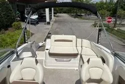 Slide: The Image of 2013 Chaparral Sunesta 224 boat interior with beige seating and canopy. - 8