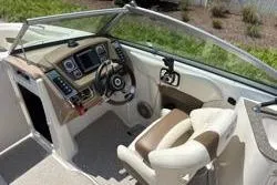 Slide: The Image of 2013 Chaparral Sunesta 224 boat interior with steering wheel and dashboard controls. - 9