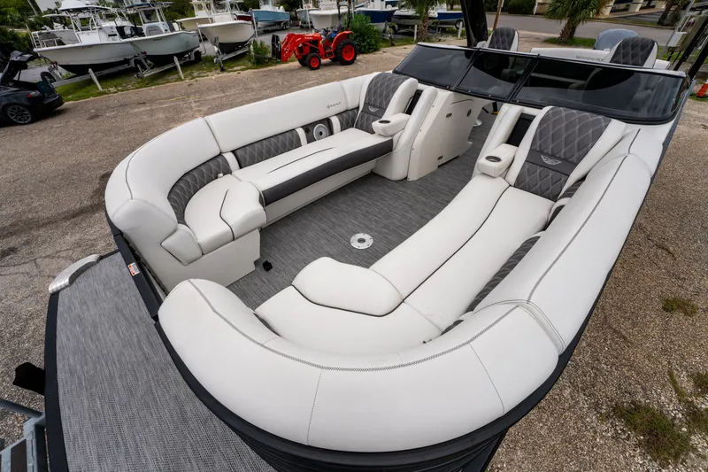 Slide: The Image of 2021 Bennington R25 Sport boat interior with luxurious white seating and modern design. - 13