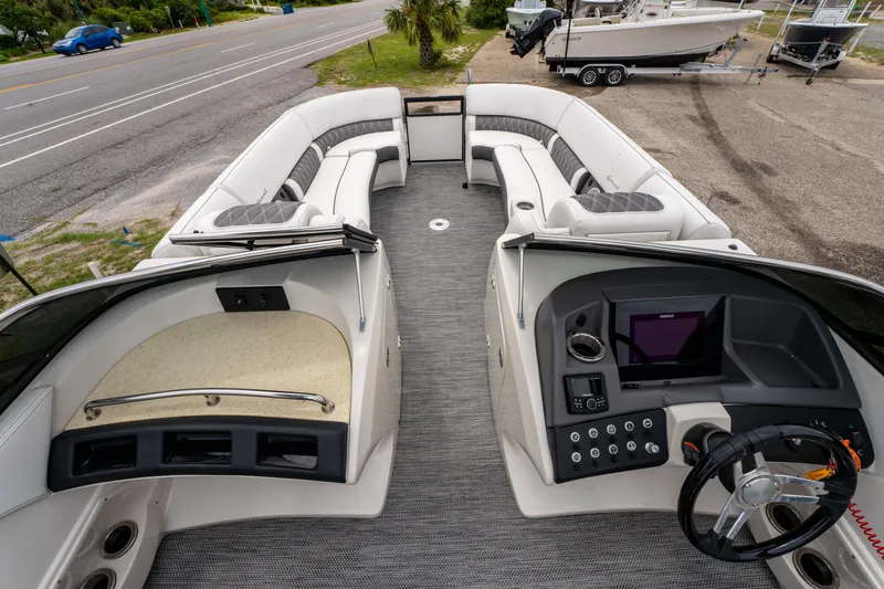 Slide: The Image of 2021 Bennington R25 Sport boat interior with plush seating and modern dashboard. - 17