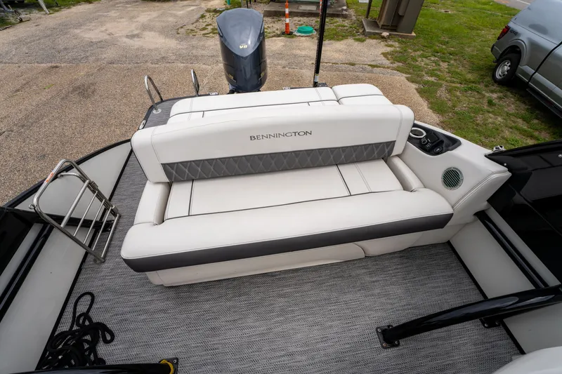 Slide: The Image of 2021 Bennington R25 Sport boat interior with white seating and outboard motor. - 19