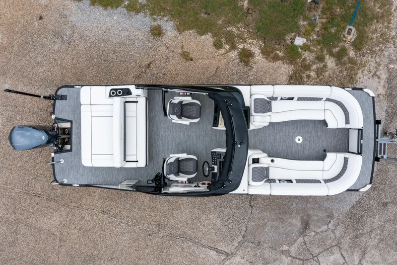 Slide: The Image of Aerial view of 2021 Bennington R25 Sport pontoon boat with white seating and gray flooring. - 2