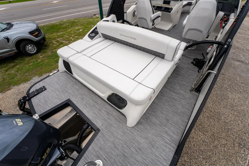 Slide: The Image of 2021 Bennington R25 Sport boat interior with white seating and Yamaha V8 engine. - 20
