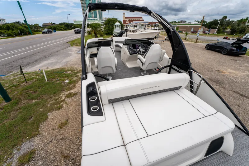 Slide: The Image of 2021 Bennington R25 Sport boat interior with sleek seating and modern dashboard. - 22