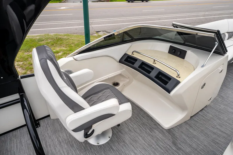Slide: The Image of 2021 Bennington R25 Sport boat interior with captain's chair and dashboard. - 23