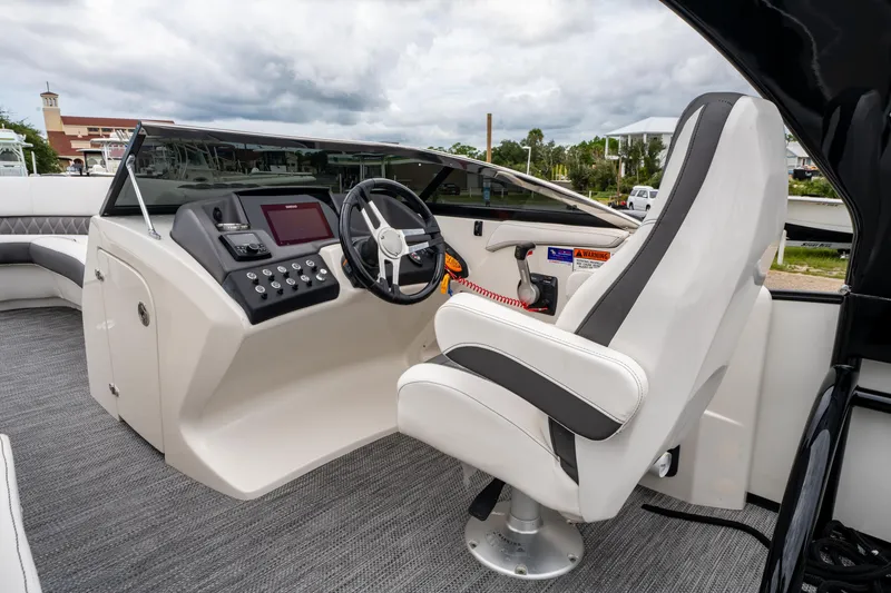 Slide: The Image of 2021 Bennington R25 Sport boat interior with steering wheel and captain's chair. - 24