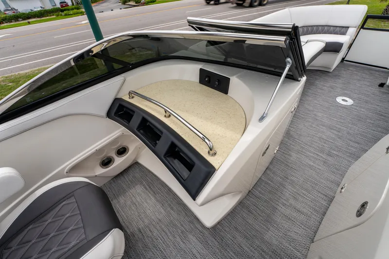 Slide: The Image of 2021 Bennington R25 Sport boat interior with sleek seating and modern dashboard design. - 28