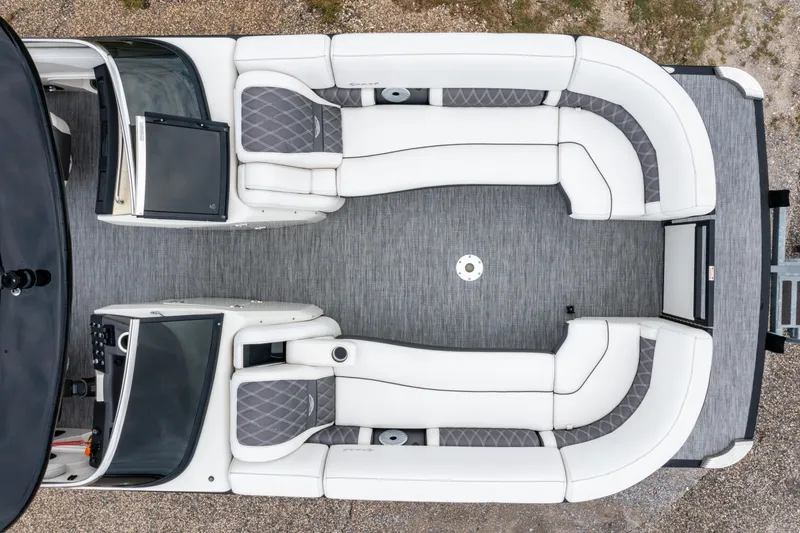 Slide: The Image of 2021 Bennington R25 Sport boat interior with white seating and gray flooring, aerial view. - 6
