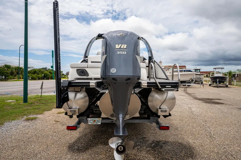 Slide: The Image of 2021 Bennington R25 Sport boat with Yamaha V8 350 engine, parked on gravel. - 8