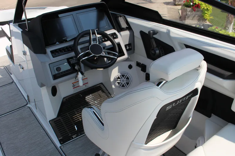 Slide: The Image of 2025 Cobalt R8 Surf boat cockpit with modern steering and control panels. - 10