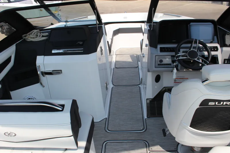 Slide: The Image of Interior of 2025 Cobalt R8 Surf boat with modern dashboard and seating. - 12