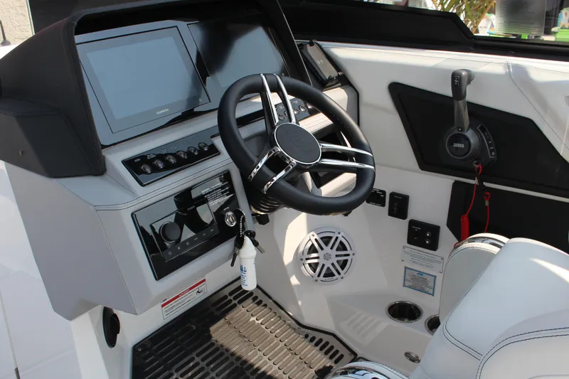 Slide: The Image of 2025 Cobalt R8 Surf boat dashboard with steering wheel and control panel. - 13