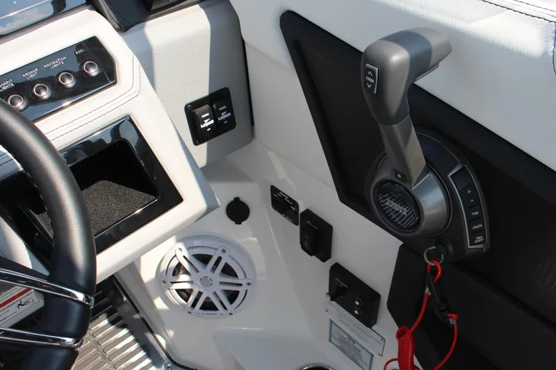 Slide: The Image of 2025 Cobalt R8 Surf boat cockpit with steering wheel, controls, and speaker system. - 14