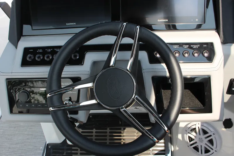 Slide: The Image of Steering wheel and dashboard of 2025 Cobalt R8 Surf boat with Garmin displays. - 15