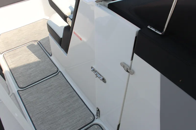 Slide: The Image of 2025 Cobalt R8 Surf boat interior with sleek seating and textured flooring. - 16