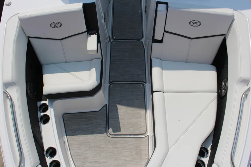 Slide: The Image of 2025 Cobalt R8 Surf boat interior with white seating and cup holders. - 19