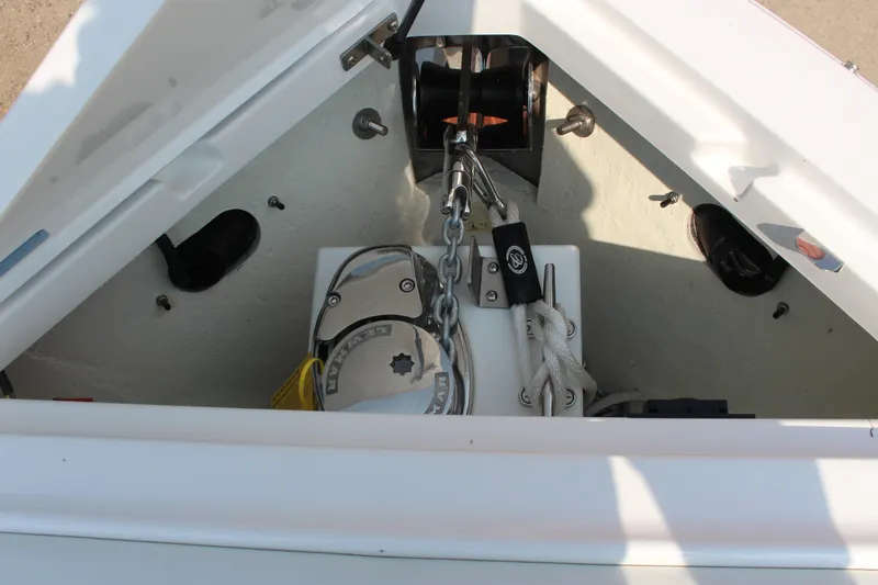Slide: The Image of Anchor compartment of 2025 Cobalt R8 Surf boat with chain and winch. - 21