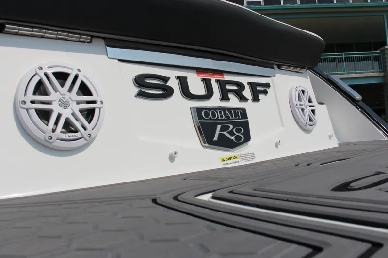 Slide: The Image of 2025 Cobalt R8 Surf boat with JL Audio speakers on deck. - 6