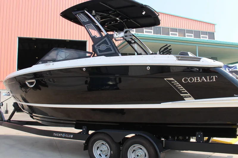 Slide: The Image of 2025 Cobalt R8 Surf boat on trailer, sleek black design. - 7