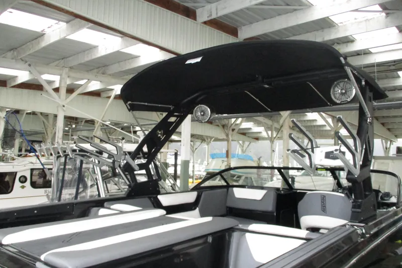 Slide: The Image of 2023 Heyday WT-2DC boat with black canopy and sleek interior design in a marina. - 16