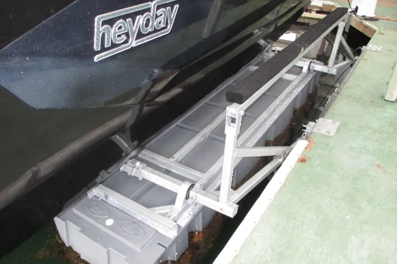 Slide: The Image of 2023 Heyday WT-2DC boat on a lift, showcasing sleek design and sturdy construction. - 21