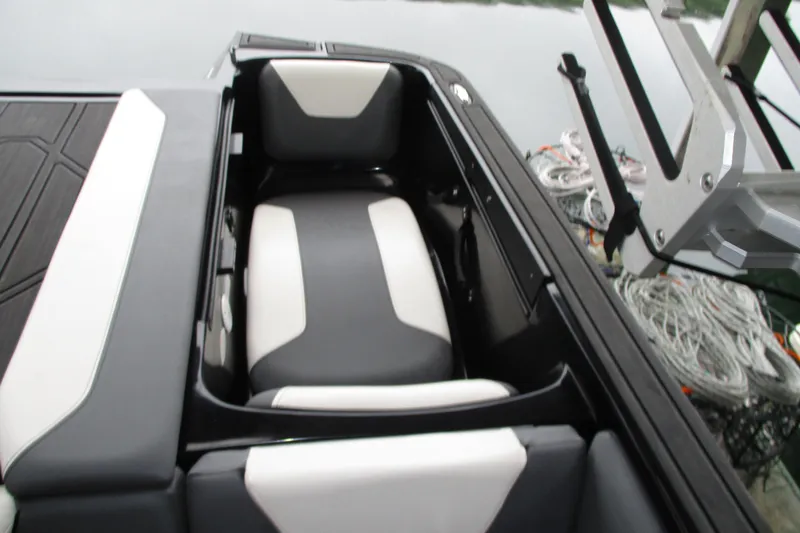 Slide: The Image of 2023 Heyday WT-2DC boat interior with black and white seating, docked by water. - 13
