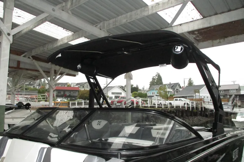 Slide: The Image of 2023 Heyday WT-2DC boat under a covered dock, showcasing sleek design and modern features. - 2