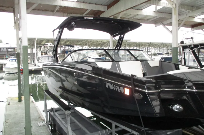 Slide: The Image of 2023 Heyday WT-2DC boat docked in a marina under a covered structure. - 3